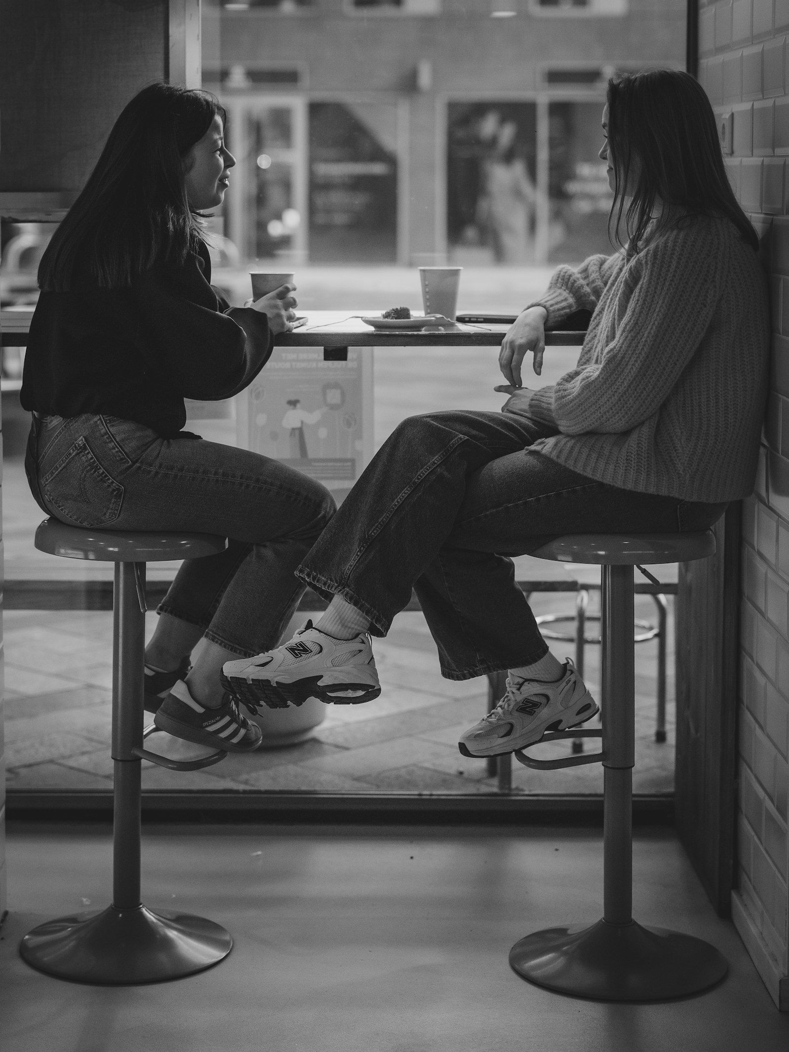 Two people having a personal conversation at a cafe